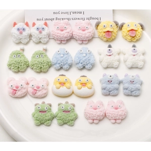 Detail of colorful cartoon dog and monster flocked resin DIY accessories for phone cases