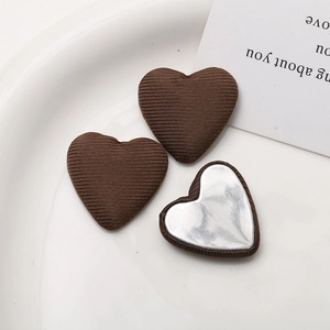 Detail shot of heart-shaped fabric buttons with textured finish for DIY hair accessories