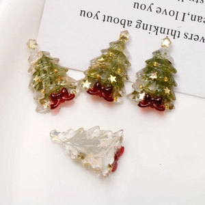 Green resin Christmas tree charms with gold foil stars and red bows for DIY crafts