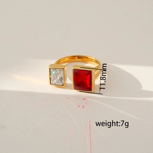 Close-up of gold adjustable ring with red and clear rectangular stones and prism effect