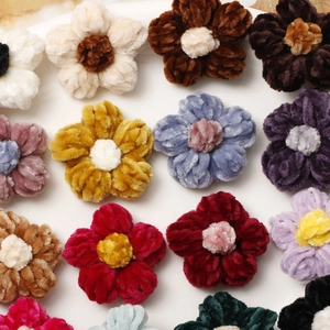 Detail of colorful handmade crochet puff flower charms for DIY jewelry and hair accessories