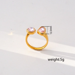 Detail view of gold open ring with dual pink gemstones and 12.5mm decoration height