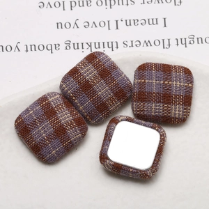 Detail of square vintage plaid fabric DIY accessories with metal flat back for jewelry making
