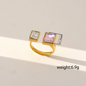 Detail view of 6.9g golden open ring featuring square white and pink crystals