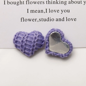 Detail showing purple knitted heart-shaped buttons with metal backing for DIY hair accessories