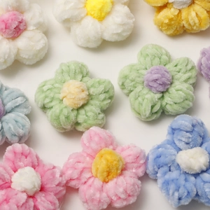 Detailed view of handmade colorful plush puff flowers for DIY jewelry making