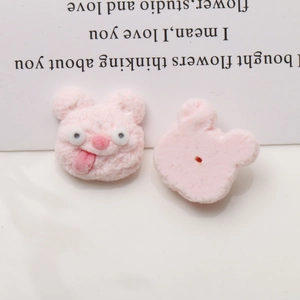 Detailed macro of a pink flocked bear resin patch for DIY phone cases and hair accessories