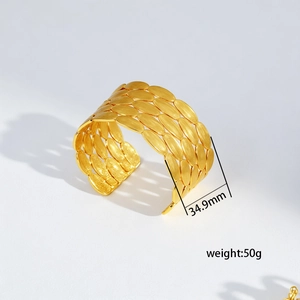Macro detail of wide gold steel bangle with brushed texture scales, 34.9mm width