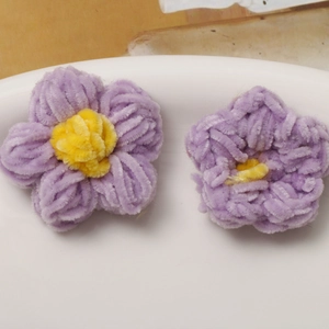 Macro detail of handmade purple and yellow plush puffer flower craft accessories