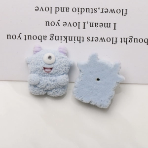 Detail view of double-sided flocked monster resin patch with soft blue fur and horns