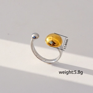 Close-up of dual-tone open ring with silver ball and 11.4mm gold hemisphere detail