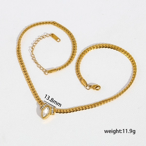 Macro view of gold snake chain with marquise zirconia and steel tag weight detail