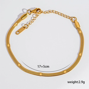 Dettaglio macro del bracciale a catena piatta in oro 18K con motivi a stella