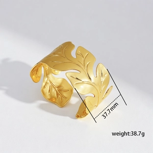 Detailed close-up of wide leaf texture gold cuff bracelet with size and weight metrics