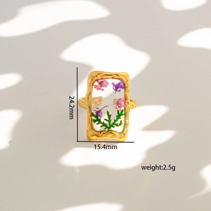 Golden stainless steel open ring with pressed purple flowers and green plants in resin
