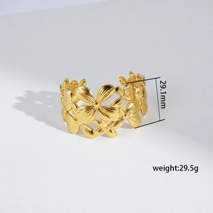Detailed macro view of gold hollow flower cuff bracelet measuring 29.1mm wide and 29.5g