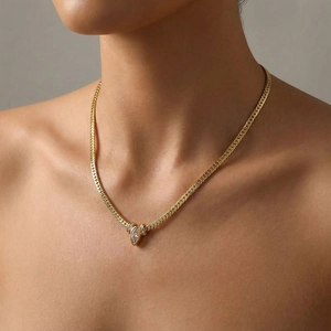 Minimalist gold snake chain necklace with a pink marquise zircon pendant on model
