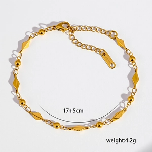 Bracciale minimalista in acciaio al titanio placcato oro 18K con perline e ciondoli