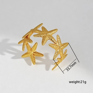 Detail of gold starfish cuff bracelet featuring realistic texture and 33.7mm width