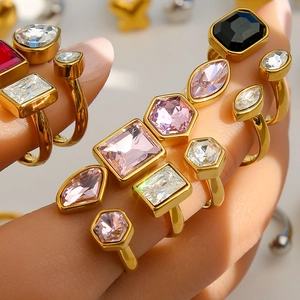 Fashionable gold stacking rings set with multicolored crystals in various geometric shapes
