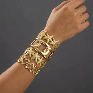 Golden stackable titanium steel bracelet set featuring starfish and heart texture designs