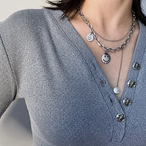 Detail of layered titanium steel Cuban chain with hollow smiley face and Love You charms