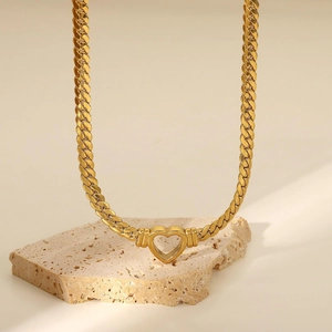 Collier rétro à chaîne gourmette dorée avec pendentif coeur évidé sur décor pierre