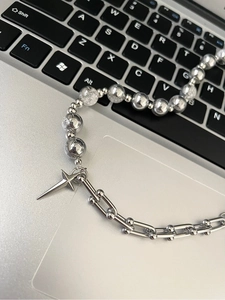 Close-up of star pendant necklace with ice crack beads on a keyboard background