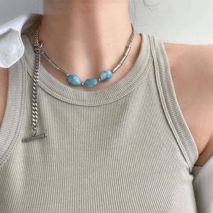 Titanium steel necklace with blue stone beads and toggle clasp on a female model