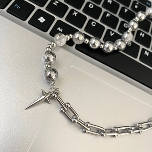 Hip-hop titanium steel necklace with star pendant and ice-crack beads on a keyboard