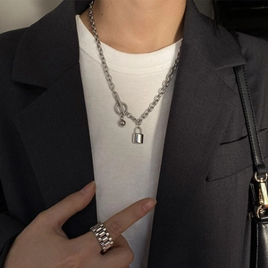 Silver titanium steel padlock necklace and chain ring set on a grey suit model