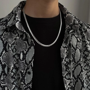 Silver titanium steel Cuban link chain necklace worn on model with black shirt