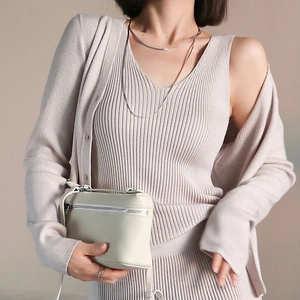 Three-piece cream ribbed knit set with cardigan, v-neck vest and skirt for women