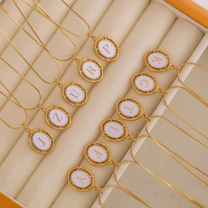 Gold-plated stainless steel oval alphabet necklace with white enamel and snake chain