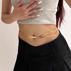 Gold double-layered snake bone body chain for women worn over a stylish outfit