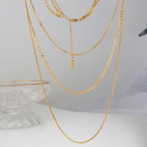 Détail du collier multi-rangs doré en acier inoxydable avec maille Figaro et serpent