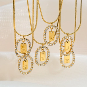 Gold stainless steel snake chain necklaces featuring diamond-encrusted letter pendants