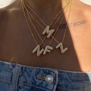 Gold plated 3D bubble initial necklace with micro-paved zircons worn by model