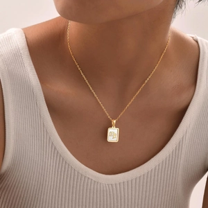 Golden titanium steel Virgo zodiac necklace with white shell pendant on a thin chain