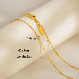 Detail of 1.6mm gold tassel necklace showing lobster clasp and 5cm extension chain