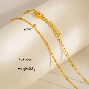 Macro view of gold stainless steel beaded necklace showing the 40+5cm chain length and 2.5g weight