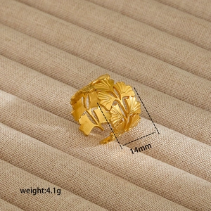 Detail of 14mm wide golden ginkgo leaf open ring showing intricate hollowed leaf textures