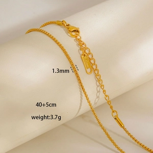 Detail of 1.3mm golden stainless steel chain with lobster clasp and s.steel tag