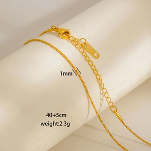 Detail of 1mm gold snake chain necklace with lobster clasp and 5cm extension