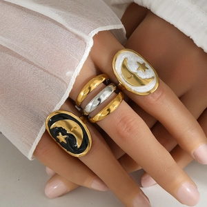 Vintage stainless steel ring set with black and white enamel celestial moon and star designs