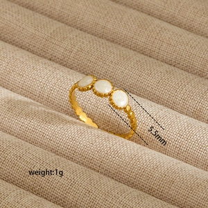 Macro detail of gold ring with wavy texture and three 5.5mm white inlaid stones