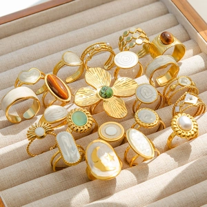 Detail of vintage gold-plated rings with turquoise and floral patterns in a velvet box