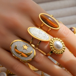 Adjustable gold plated stainless steel ring set with shell and gemstone details