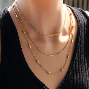 Three-layer gold stainless steel necklace set with snake chain and beads on female model