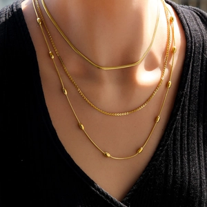 Three-layer gold stainless steel necklace set with sleek snake chains and bead accents